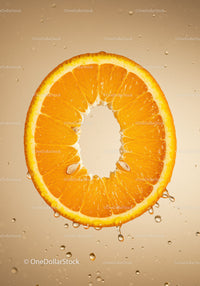 Fresh orange slice suspended in sparkling water droplets
