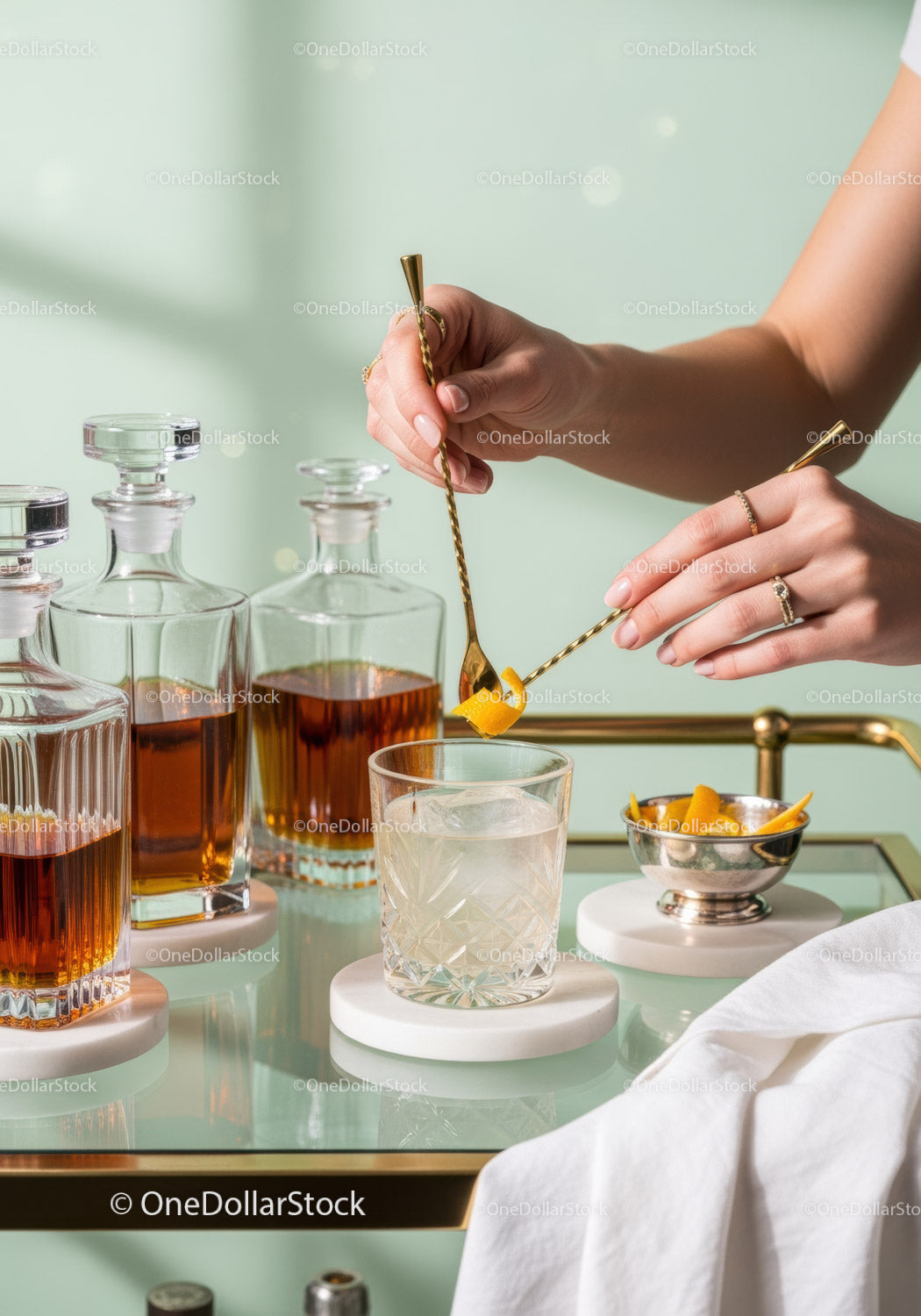 Elegant Cocktail Preparation with Gold Tools and Crystal Glasses