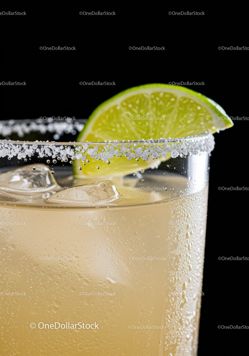 Refreshing cocktail with salted rim and lime wedge