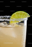 Refreshing cocktail with salted rim and lime wedge