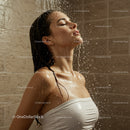 Woman Enjoying Refreshing Shower with Water Splash in Modern Bathroom