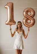 Young woman celebrating eighteenth birthday with balloons