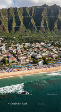 Scenic Coastline with Beachfront Resort and Mountain Background