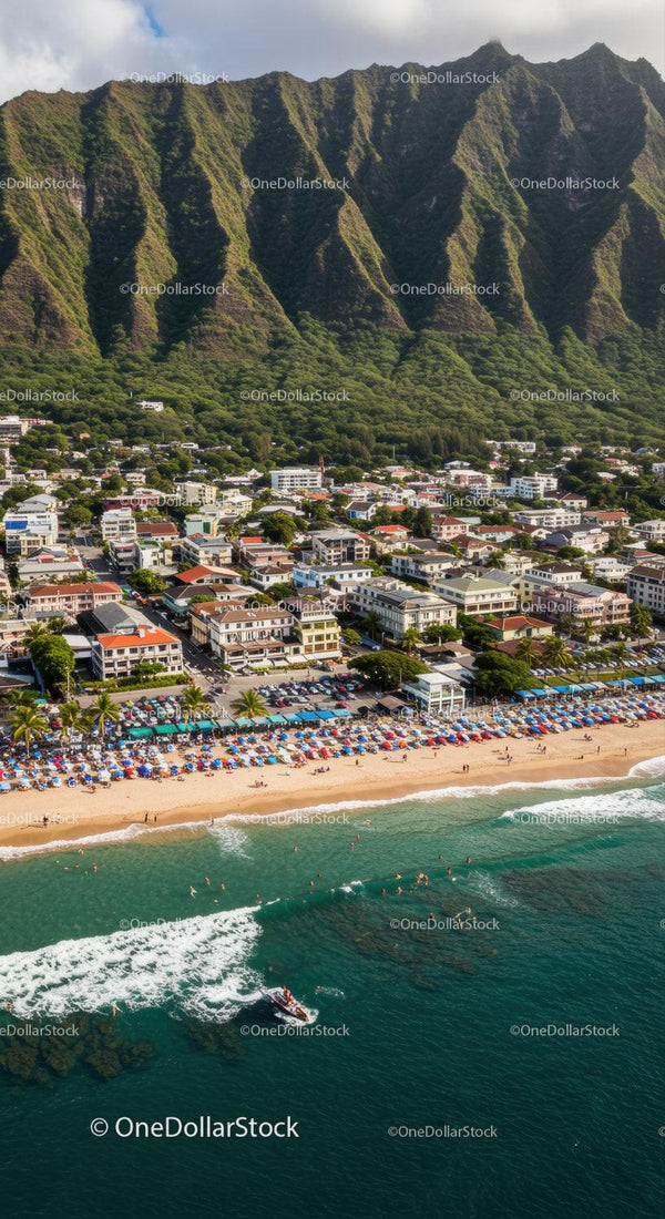 Scenic Coastline with Beachfront Resort and Mountain Background