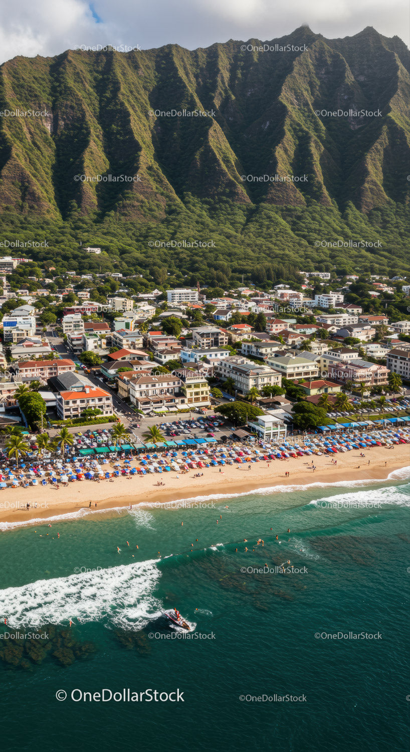 Scenic Coastline with Beachfront Resort and Mountain Background