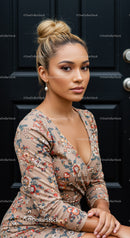 Young woman with elegant bun and floral dress outdoors
