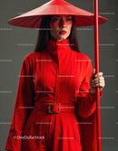 Elegant Woman in Red Dress with Accessories Against Red Background