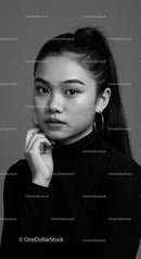 Elegant Black and White Portrait of Young Woman with Hoop Earrings