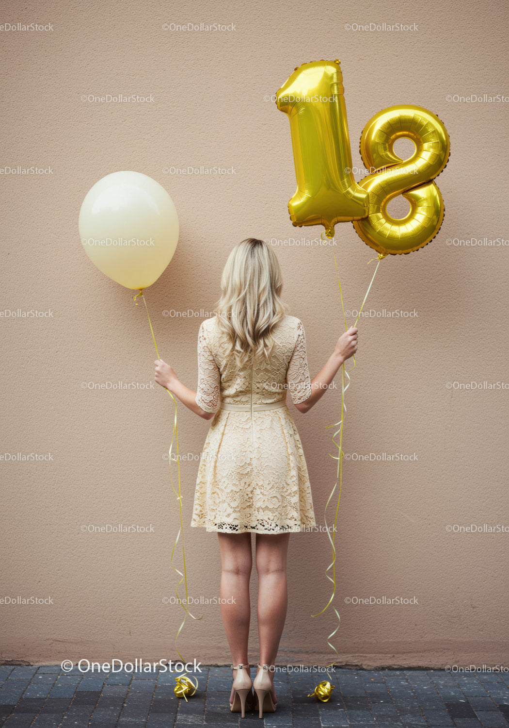 Woman in lace dress holding 18th birthday balloons
