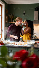 Couple Playfully Baking Heart Cookies in Cozy Kitchen
