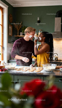 Couple Playfully Baking Heart Cookies in Cozy Kitchen