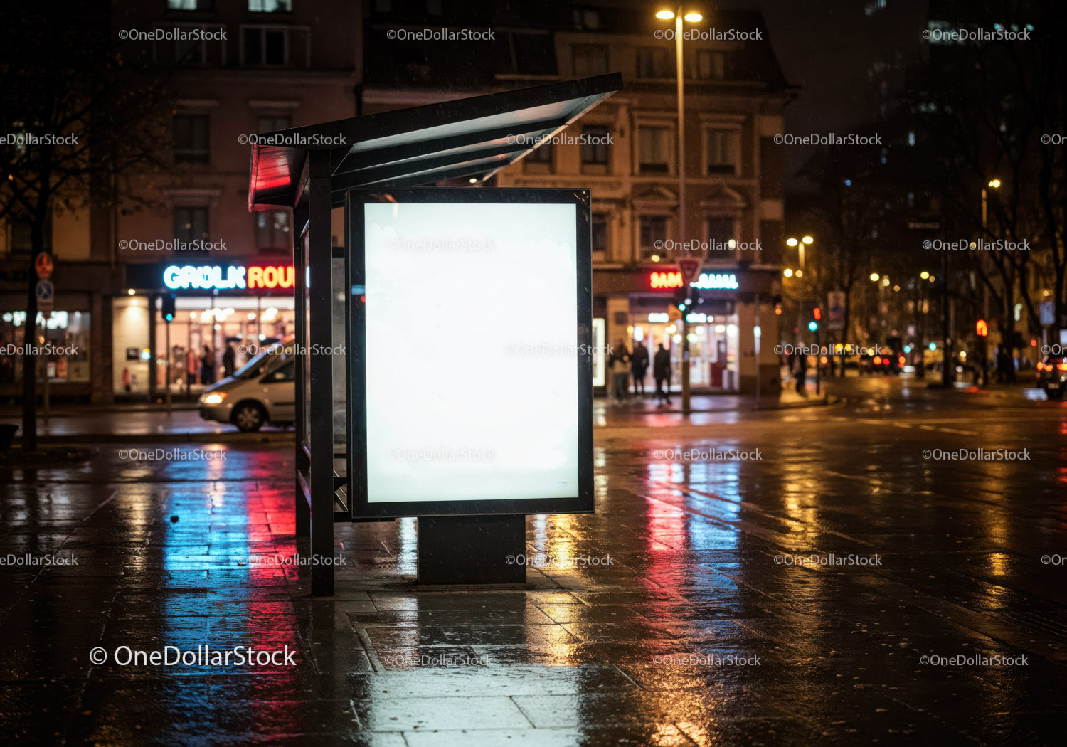 Nighttime City Street with Illuminated Bus Stop and Wet Pavement