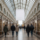 People walking in elegant glass-roofed shopping arcade