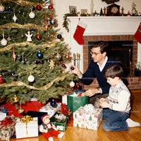 Father and son decorating Christmas tree together