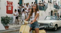 Cheerful Woman Riding Vintage Scooter on a Sunny City Street