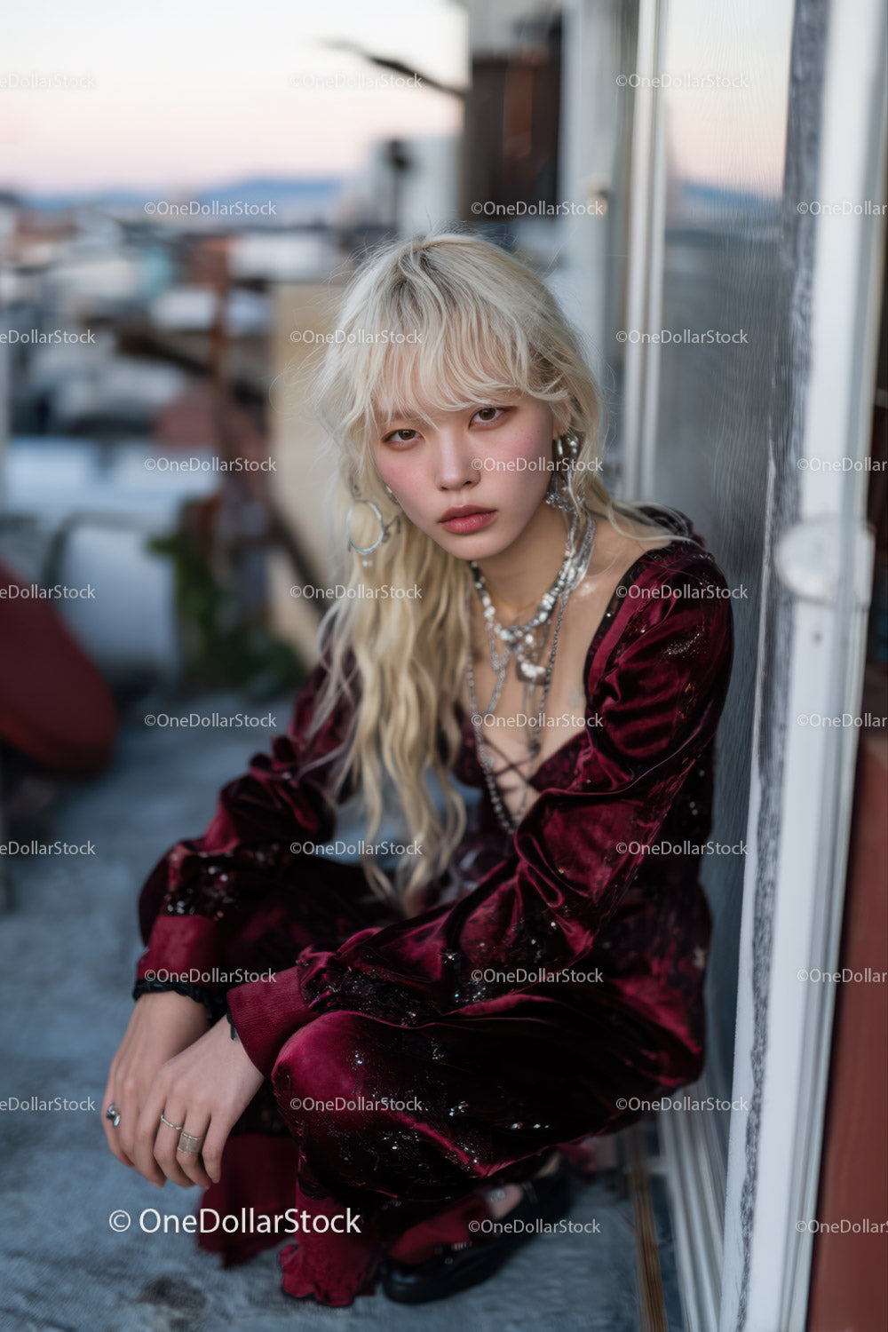 Stylish Woman Sitting on Rooftop with Cityscape Background