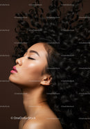 Profile of serene woman with voluminous curly hair