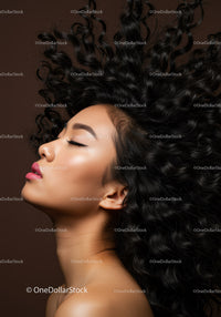 Profile of serene woman with voluminous curly hair