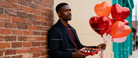 Man Holding Heart Balloons and Chocolates on Valentines