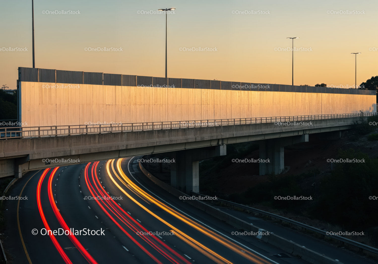 City Traffic Lights and Highway Overpass at Sunset with Motion Light Trails