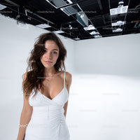 Elegant Young Woman in White Dress with Jewelry in Studio