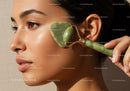 Beautiful Woman Using Jade Roller for Facial Skin Rejuvenation