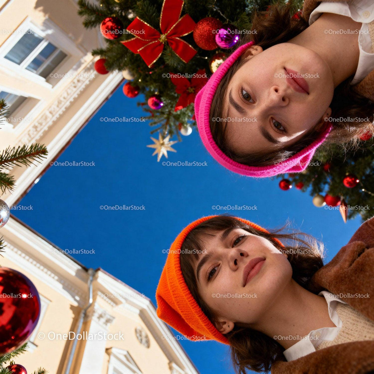 Two young women enjoying festive Christmas decorations outdoors