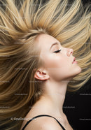 Blonde woman with windblown hair and closed eyes