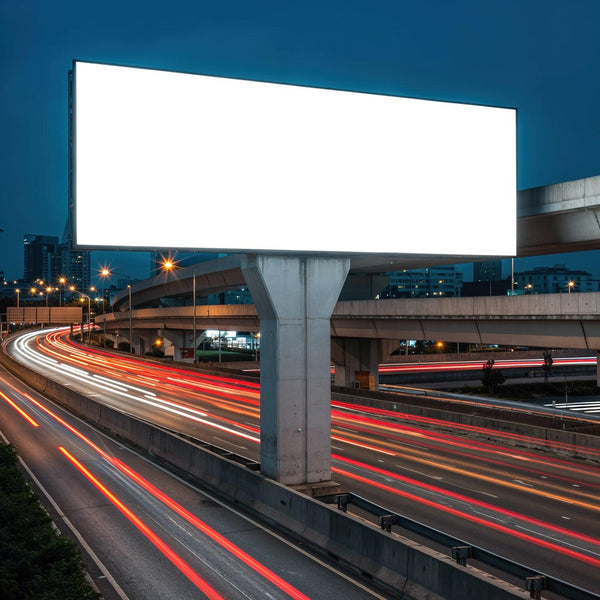 Empty billboard over busy illuminated urban highway at night JPG Mockup Image