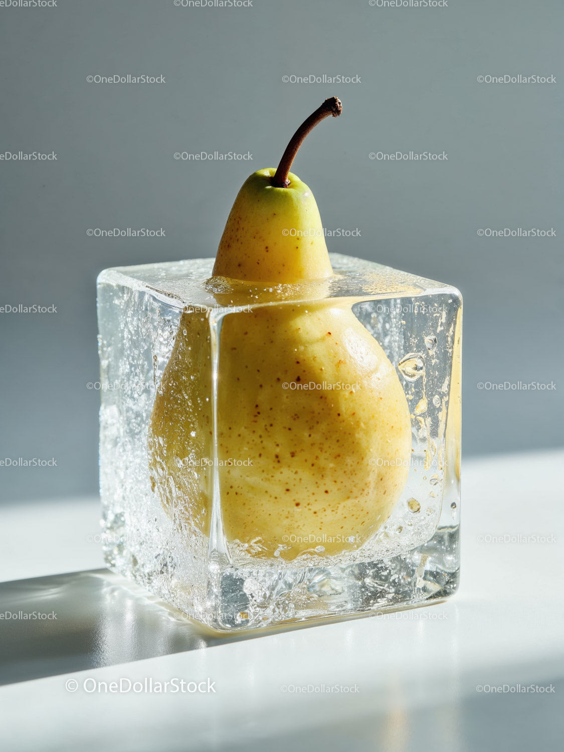 Yellow Pear Frozen Inside a Transparent Ice Cube
