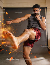 Focused martial artist delivering a powerful kick