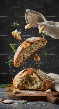 Rustic sourdough bread levitating with fresh rosemary