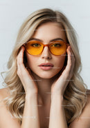 Elegant Woman Wearing Orange Tinted Sunglasses in Stylish Portrait