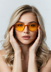 Elegant Woman Wearing Orange Tinted Sunglasses in Stylish Portrait