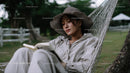 Relaxing Woman Reading Book in Hammock Outdoors in Nature