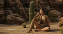 Elegant Model in Brown Suit Posing Amidst Desert Rocks