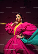 Fashion Model in Vibrant Pink and Yellow Flowing Gown