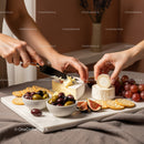 Gourmet Cheese Platter with Grapes and Figs on Wooden Surface