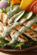Grilled Chicken Salad with Cucumber and Herb Dressing in Wooden Bowl