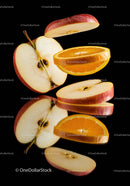 Sliced apple and orange pieces floating on black