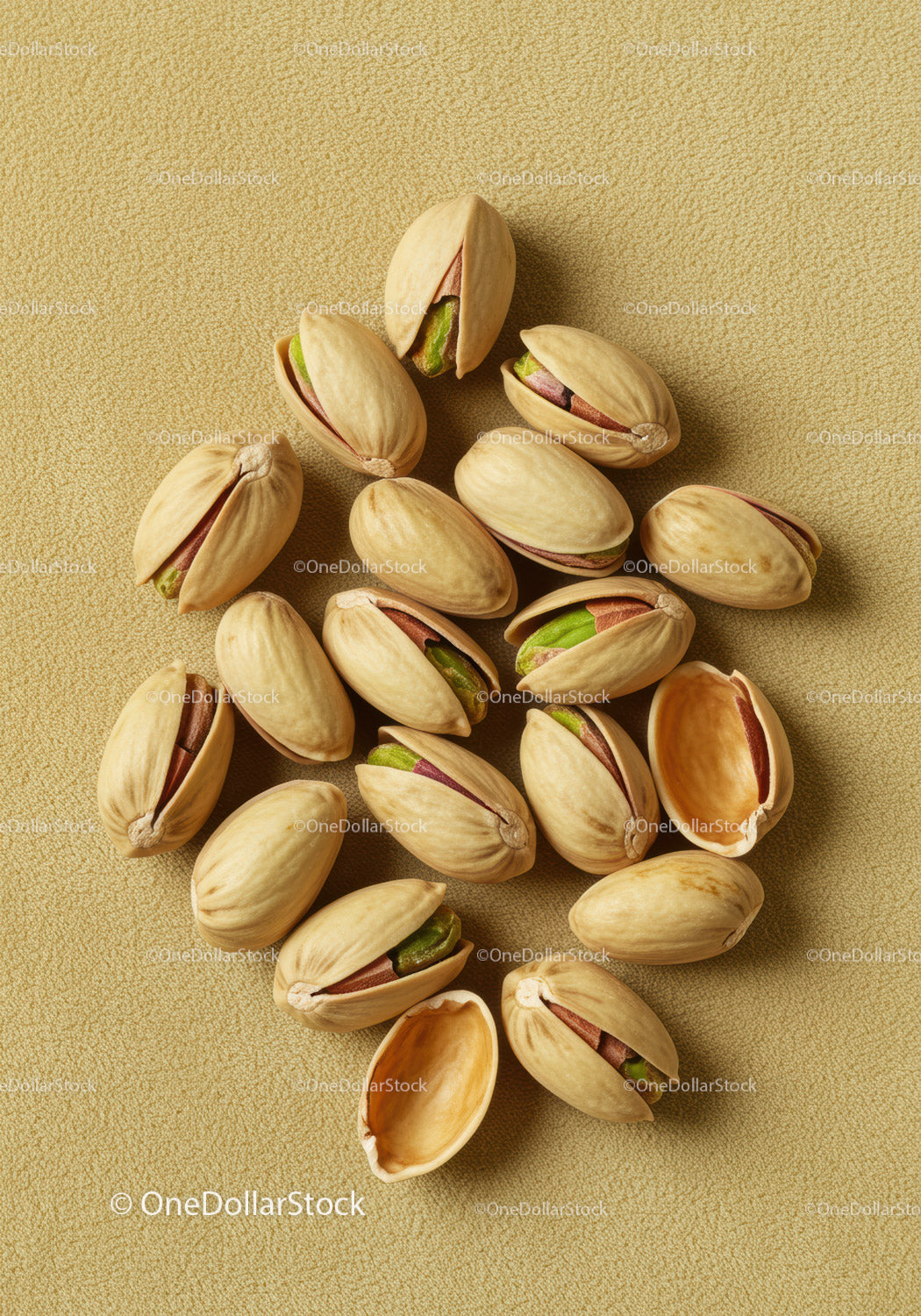 Close up of roasted pistachios in shells on textured background