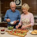 Senior couple preparing colorful appetizers in kitchen