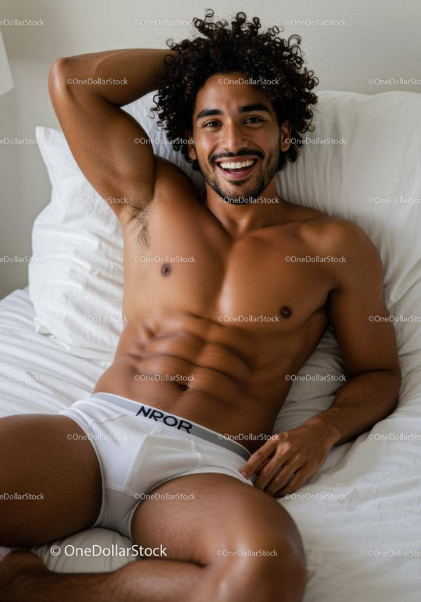 Smiling man relaxing on bed in white underwear