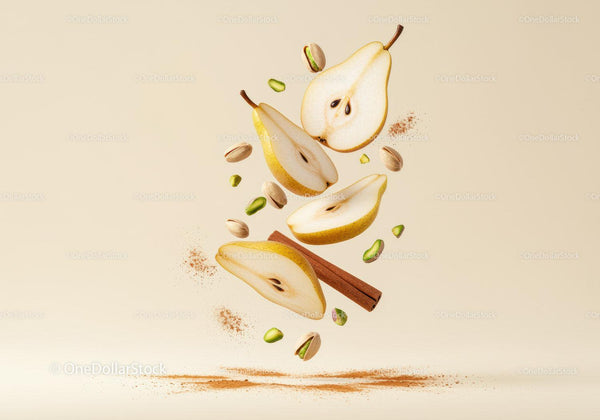 Fresh sliced pears with cinnamon and pistachios floating