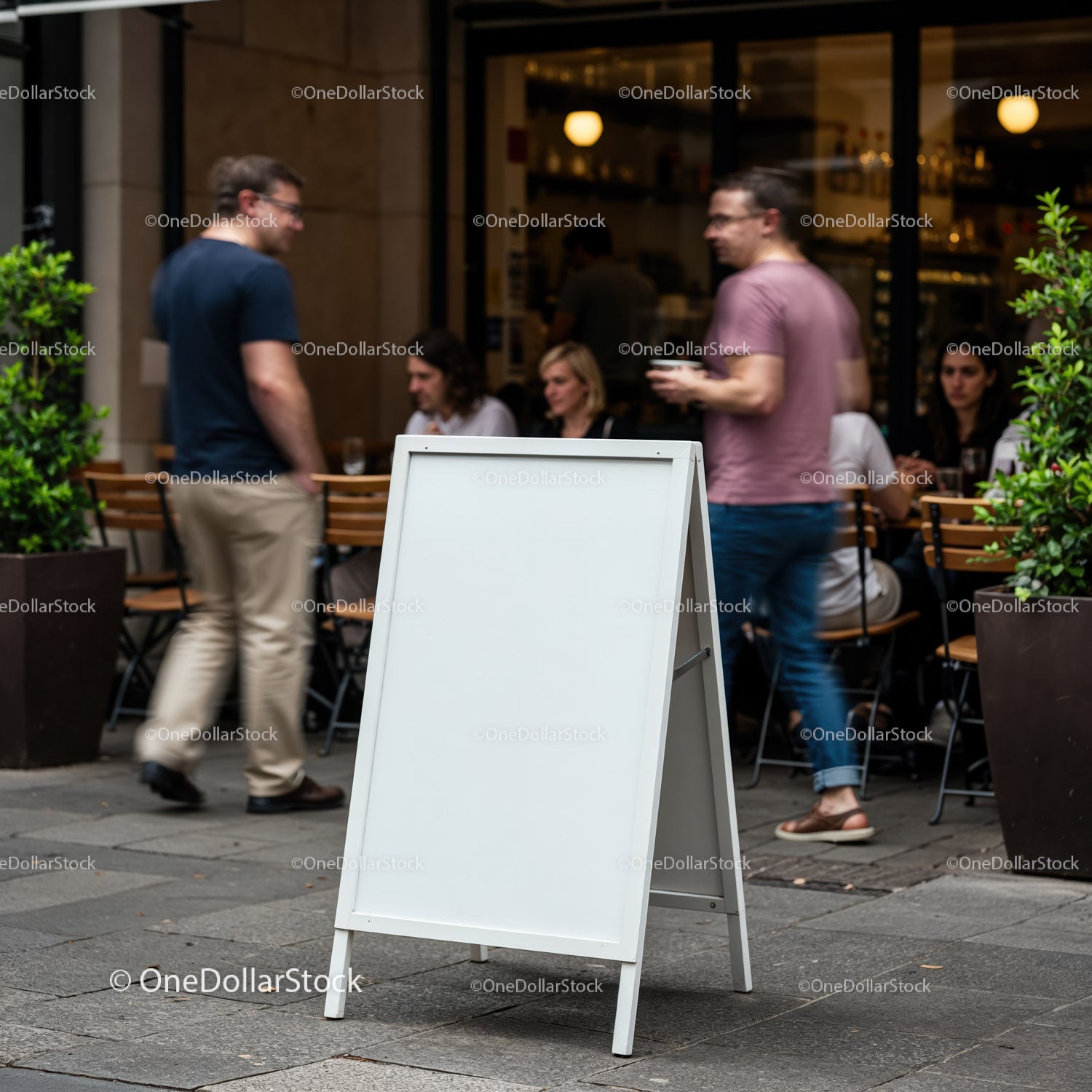 Blank sidewalk sandwich board in busy outdoor cafe scene