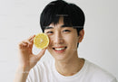 Happy Young Man with Lemon Slice Close-Up Portrait