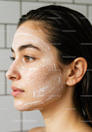 Close-up of woman cleansing skin with foaming facial wash