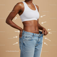 Slim Woman in White Sports Bra and Loose Jeans Measuring Waist