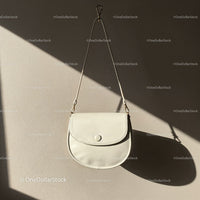 Minimalist White Leather Crossbody Bag Hanging on Wall