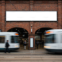 Blurred trams passing historic brick station entrance